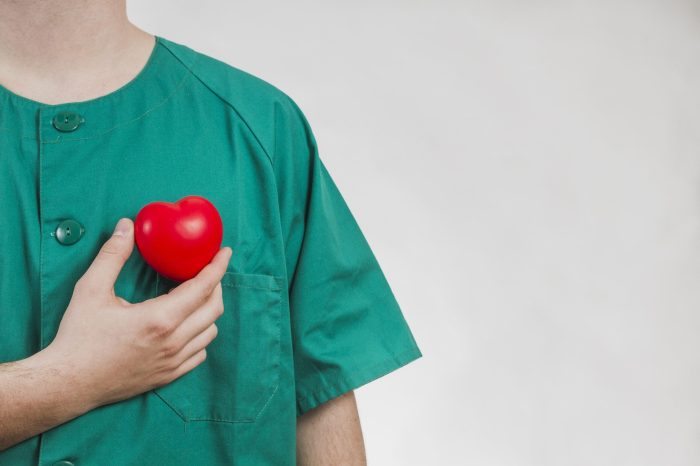 nurse-showing-plastic-heart